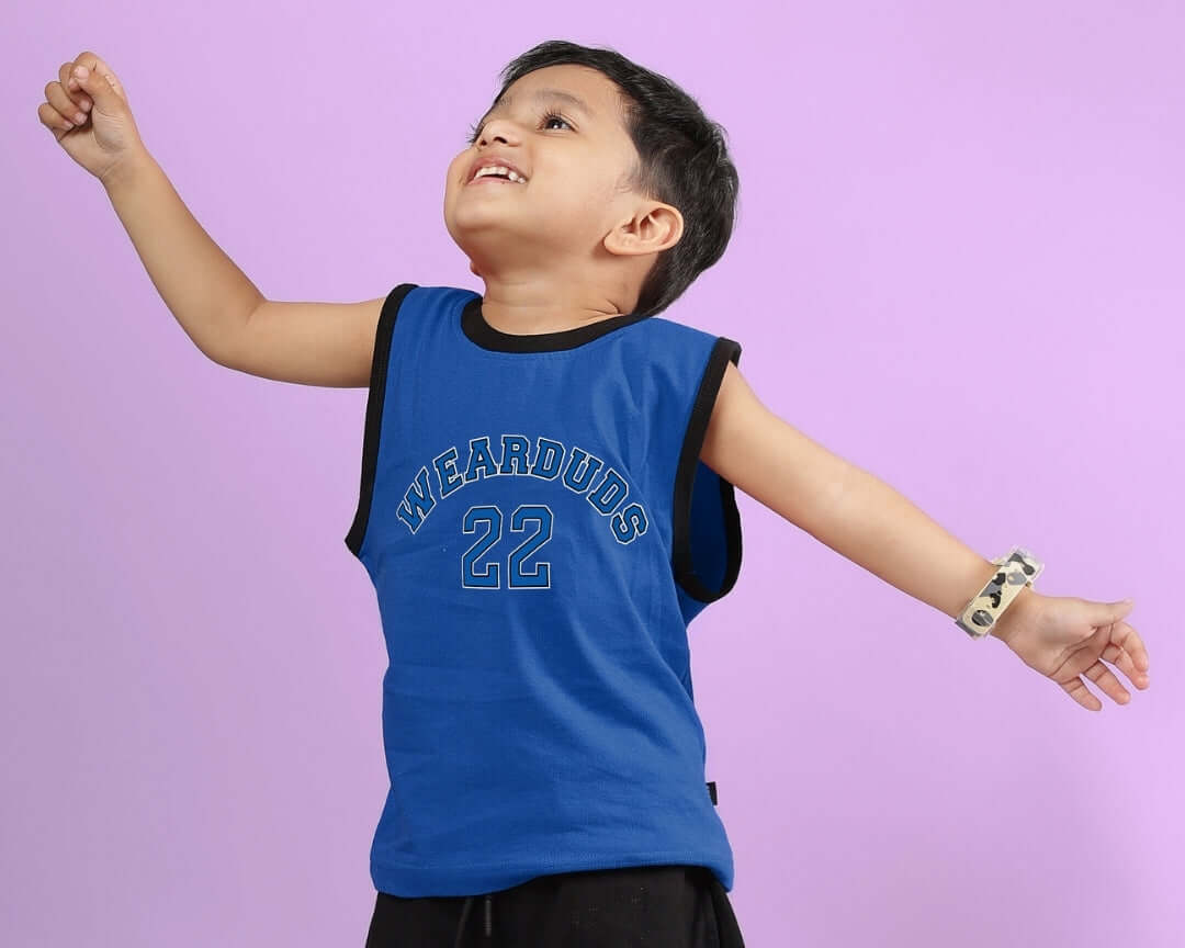 Joyful child wearing blue Amiga t-shirt from DUDS, showcasing comfortable fashion for boys and girls.