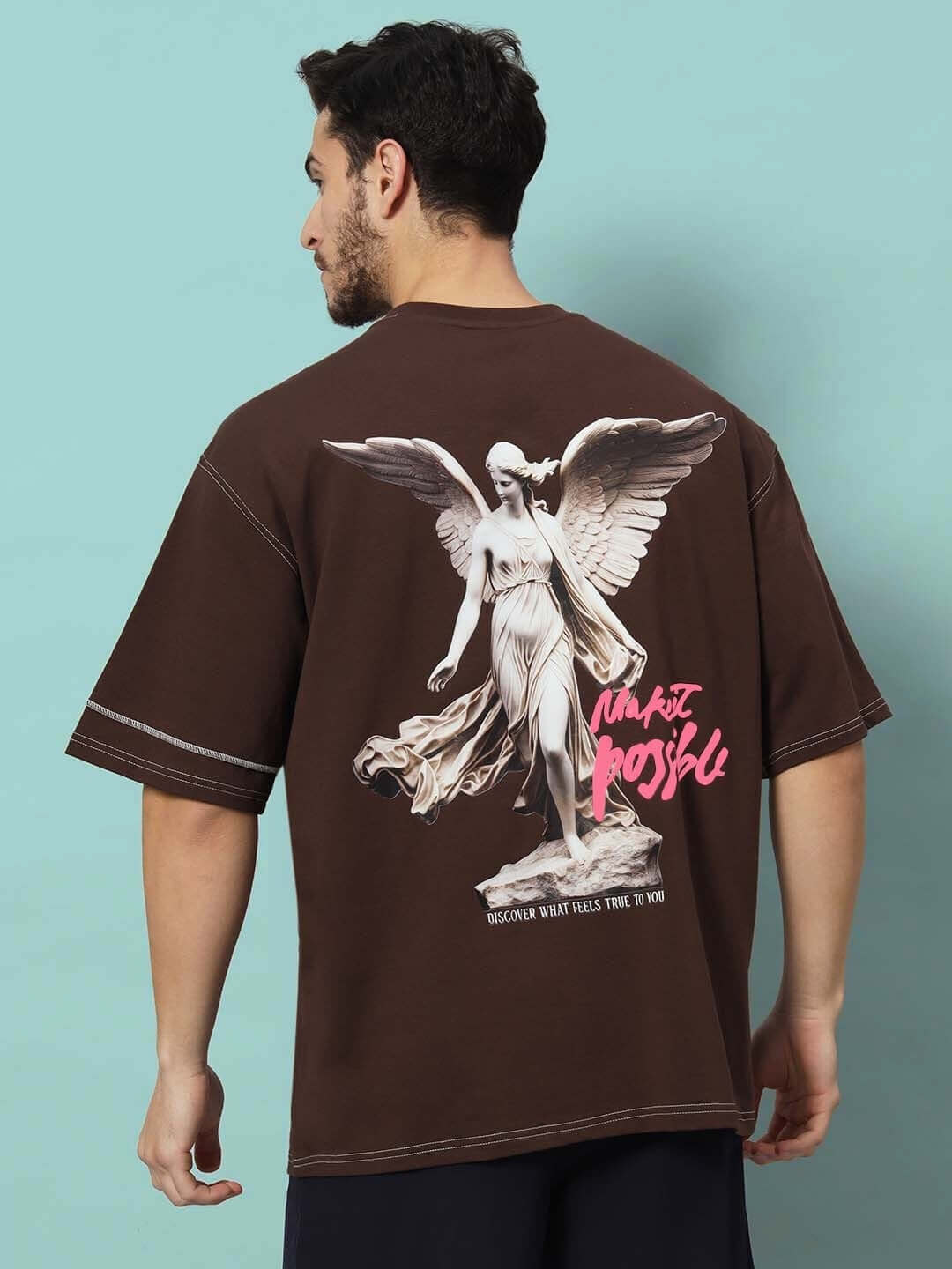 Back view of MAKE IT POSSIBLE CONTRAST STITCHED OVER-SIZED T-SHIRT BROWN featuring a graphic print and contrast stitching.