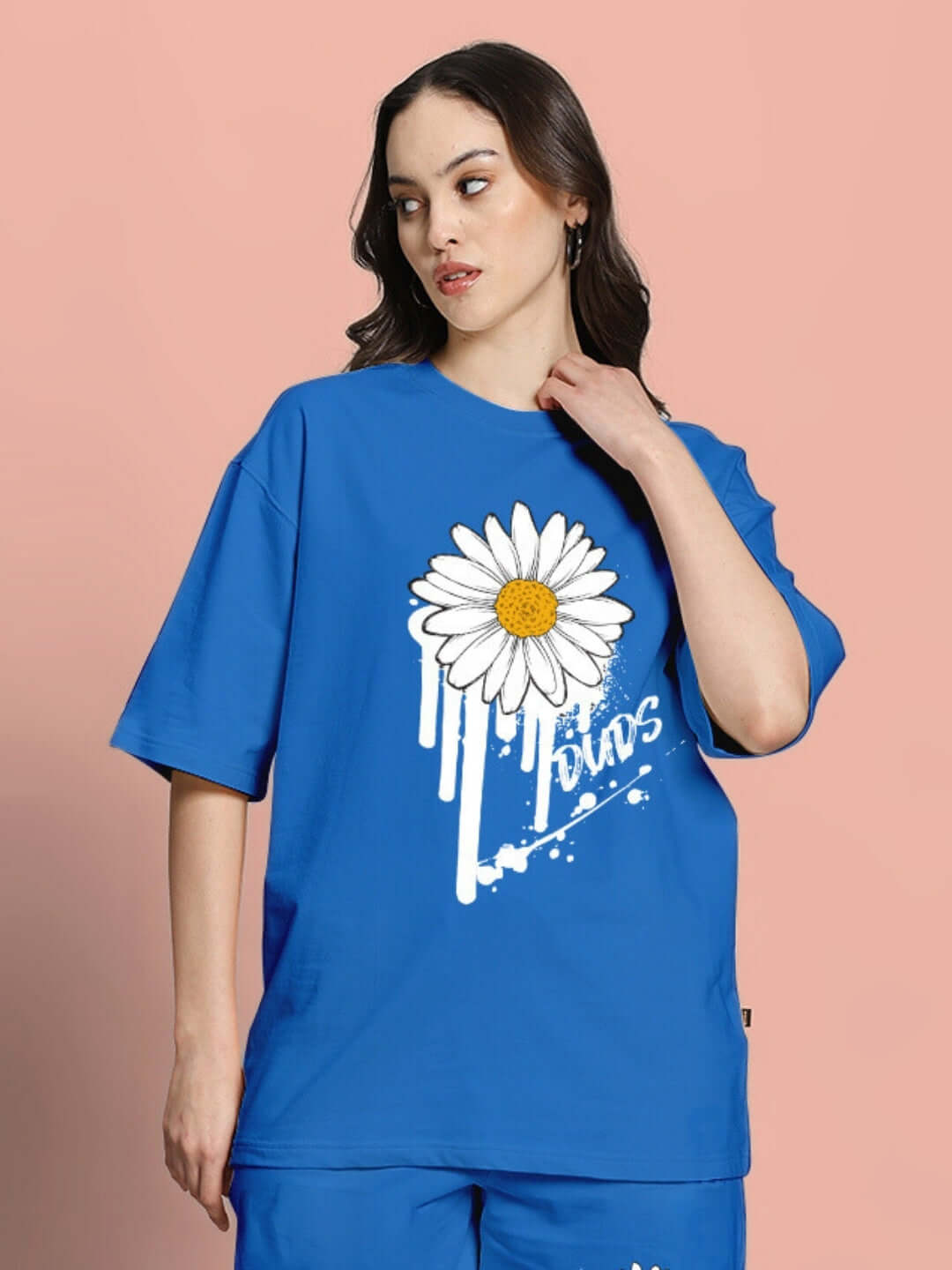 Model wearing Women's Heliathus blue oversized t-shirt with daisy print, made from premium cotton fabric.