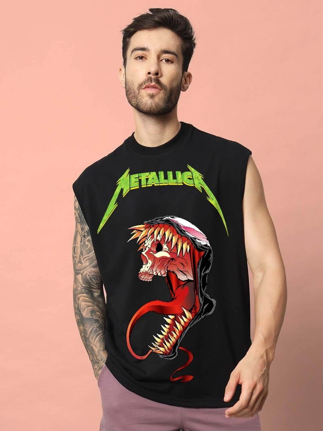 Man wearing a sleeveless black t-shirt with a Metallica graphic and a fierce skull design in front.