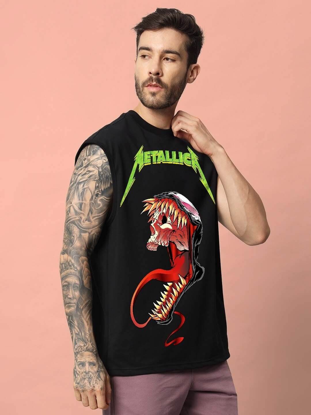 Man wearing Carnage Gym T-Shirt in black with graphic design, showcasing tattoos, against a pink background.