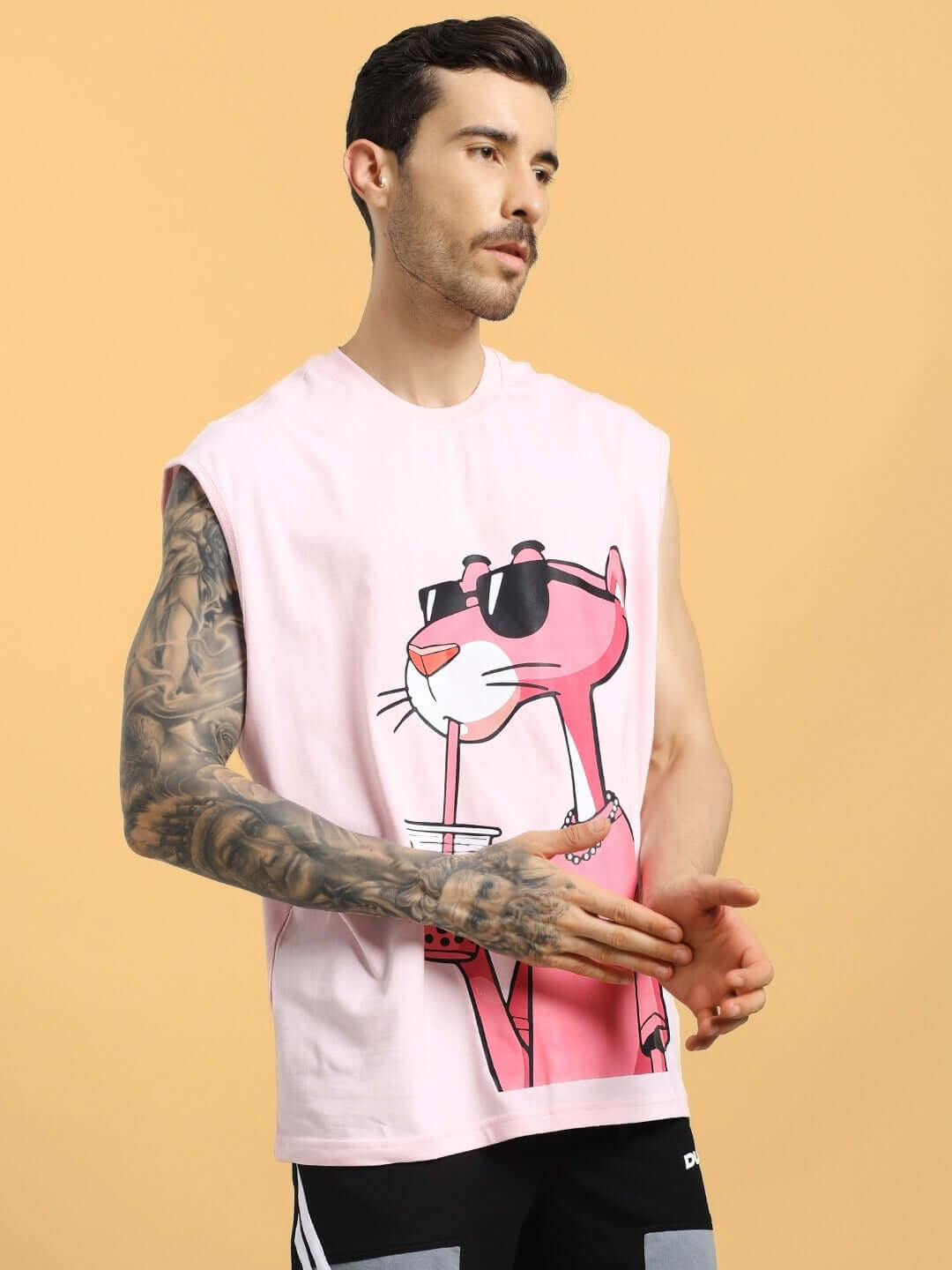 Model wearing pink t-shirt with Pink Panther print, showcasing custom fit option from DUDS. Suitable for casual, relaxed style.
