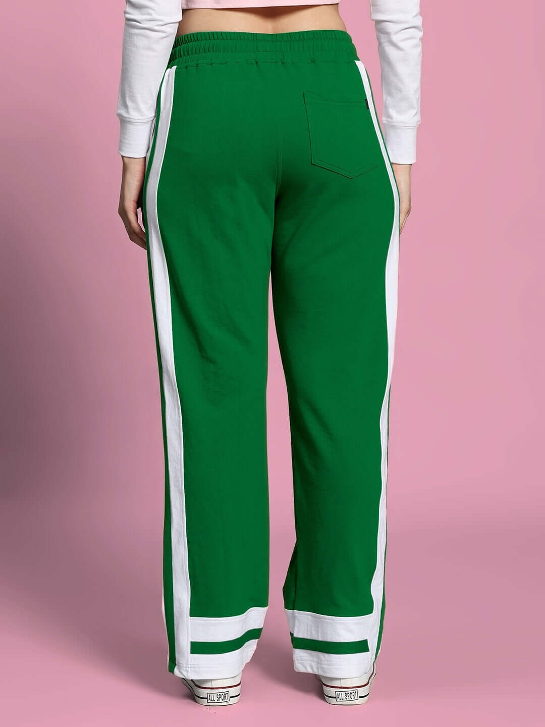 Back view of Women's Ronny Side Stripe Jogger in green with white stripes, showing comfortable fit and stylish design on pink background.