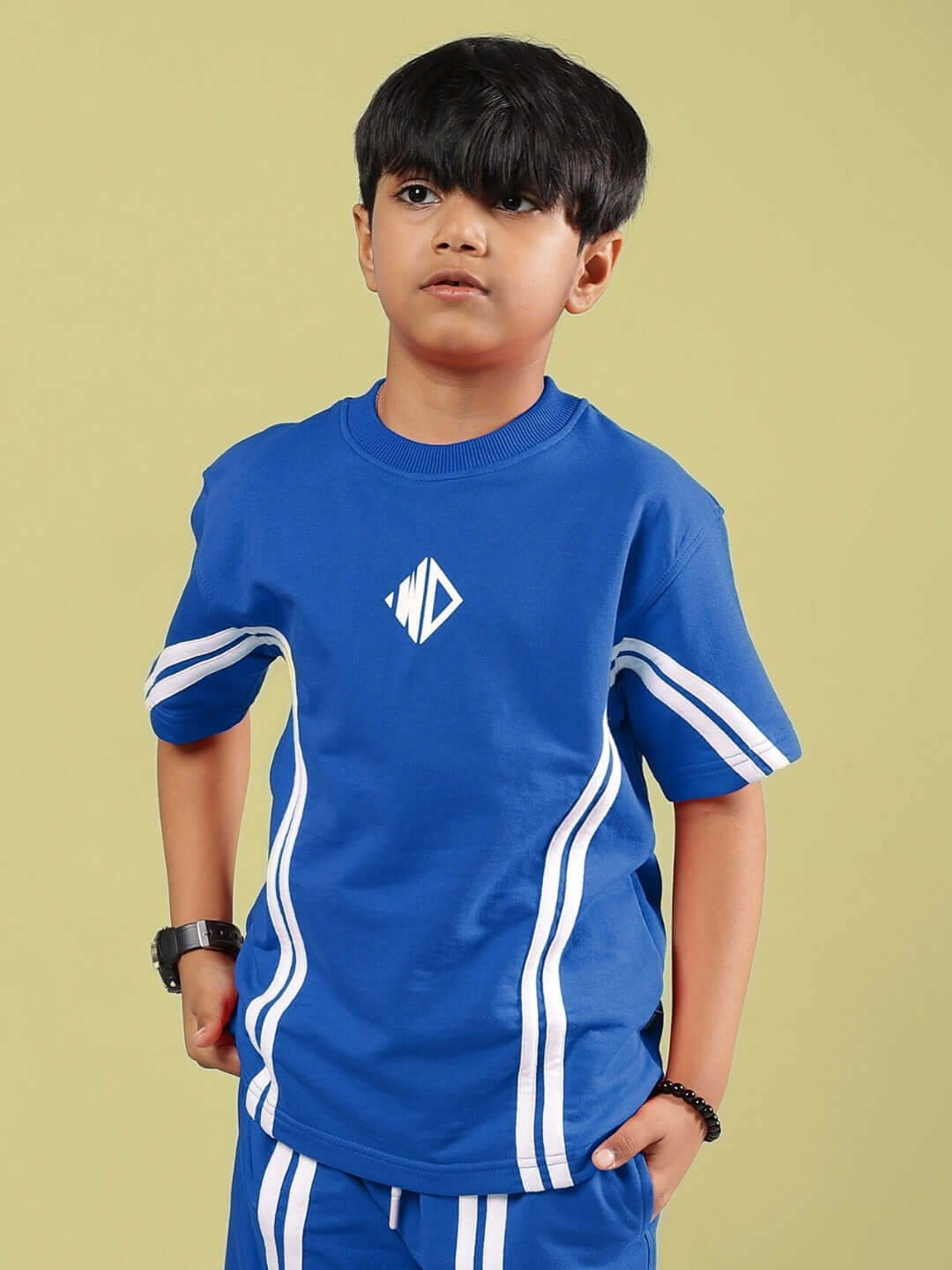 Boy wearing Outlook blue t-shirt by DUDS, featuring white stripes and logo, available for custom fit and made to order.