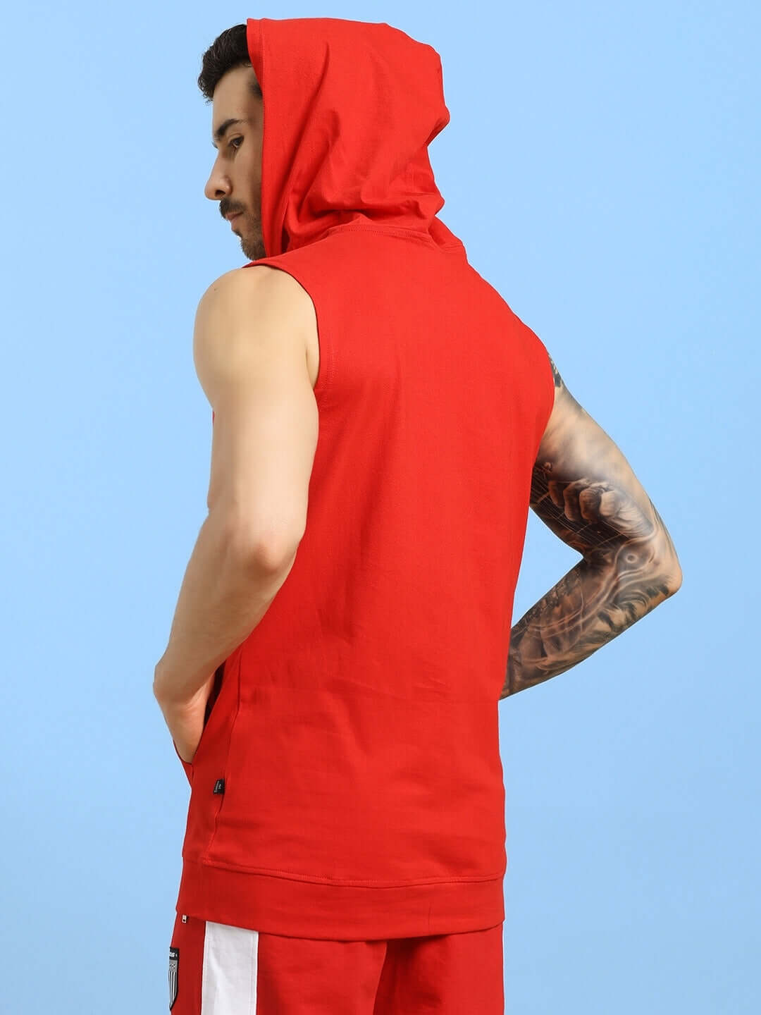 Man wearing red sleeveless gym hooded t-shirt, showcasing back view, customizable size option available for a perfect fit.