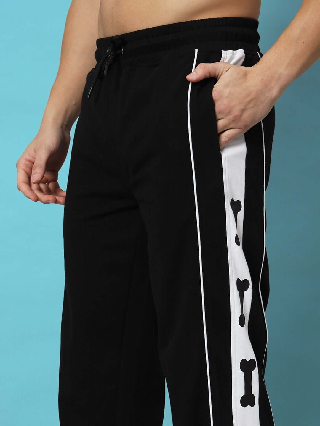 Model wearing TIBIA CONTRAST PANEL JOGGERS BLACK with unique side panel design