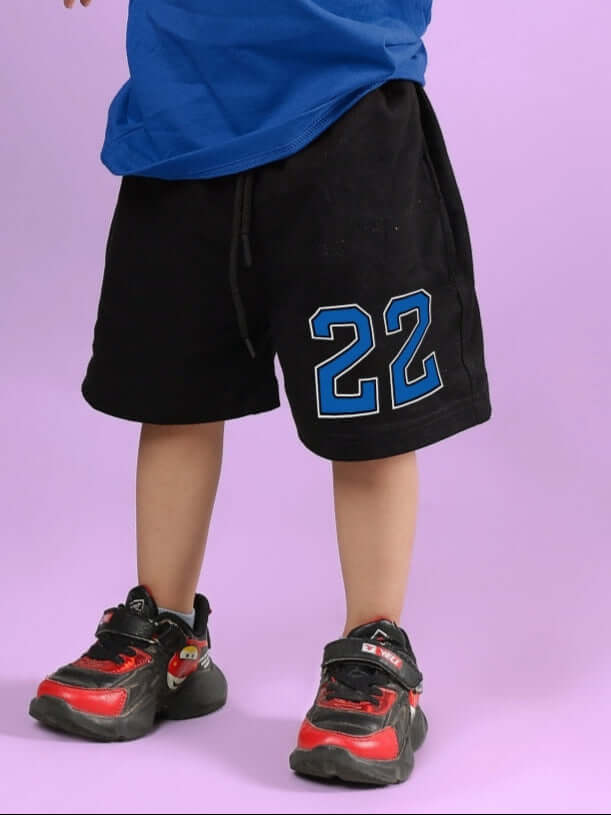 Child wearing Amiga black and blue shorts with number 22, showcasing casual fit for boys and girls.