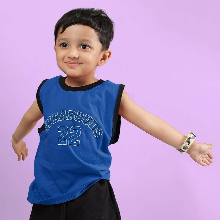 Young child wearing a blue Amiga t-shirt, designed for boys and girls, against a purple background.