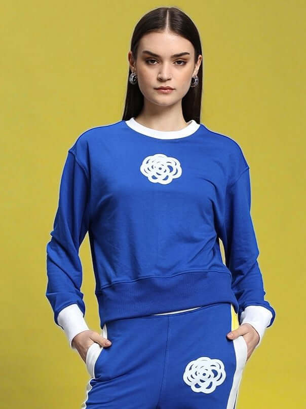 Woman wearing a royal blue Women's Jessflick relaxed fit sweatshirt with floral design, made from premium cotton blend, front view.