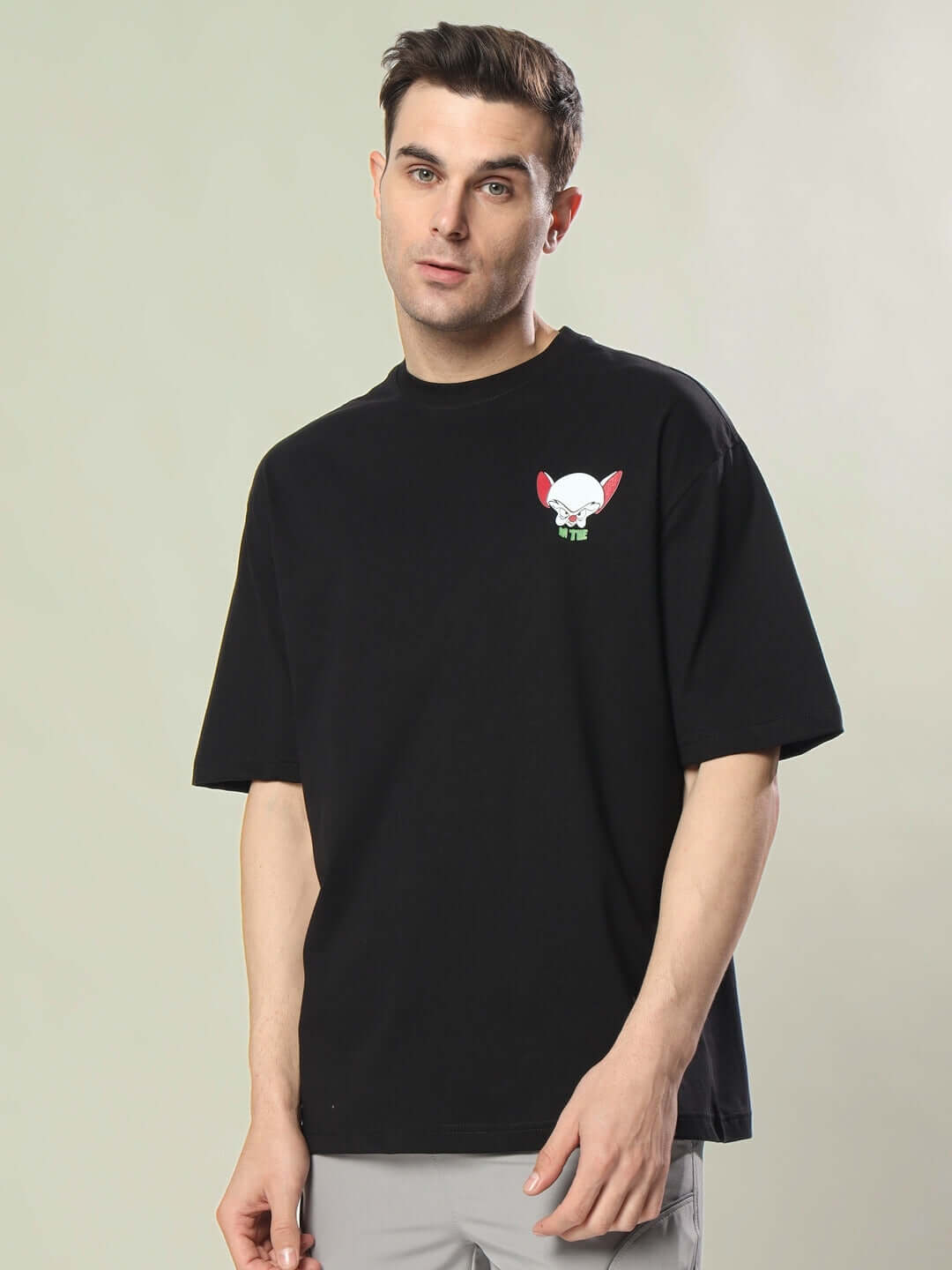 Model wearing INSANE BRAIN OVER-SIZED T-SHIRT BLACK, featuring a unique design, perfect for casual wear.