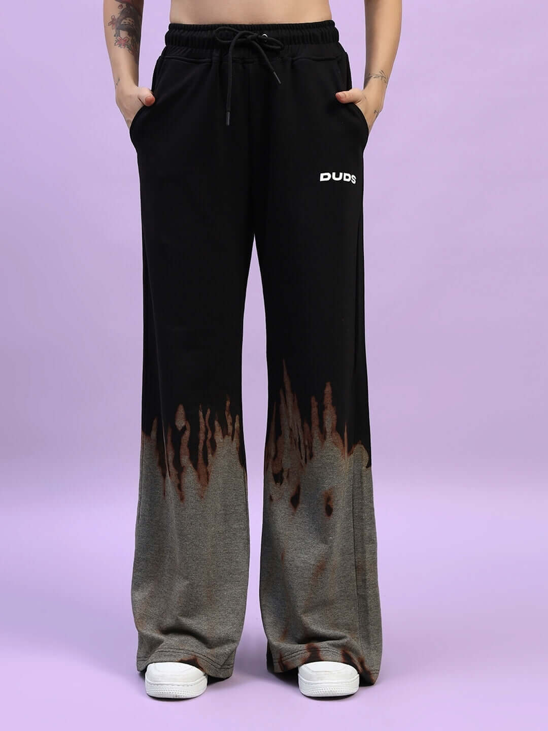 Black tie-dye jogger pants with flame design, featuring a baggy fit and DUDS logo, ideal for comfortable and stylish wear.