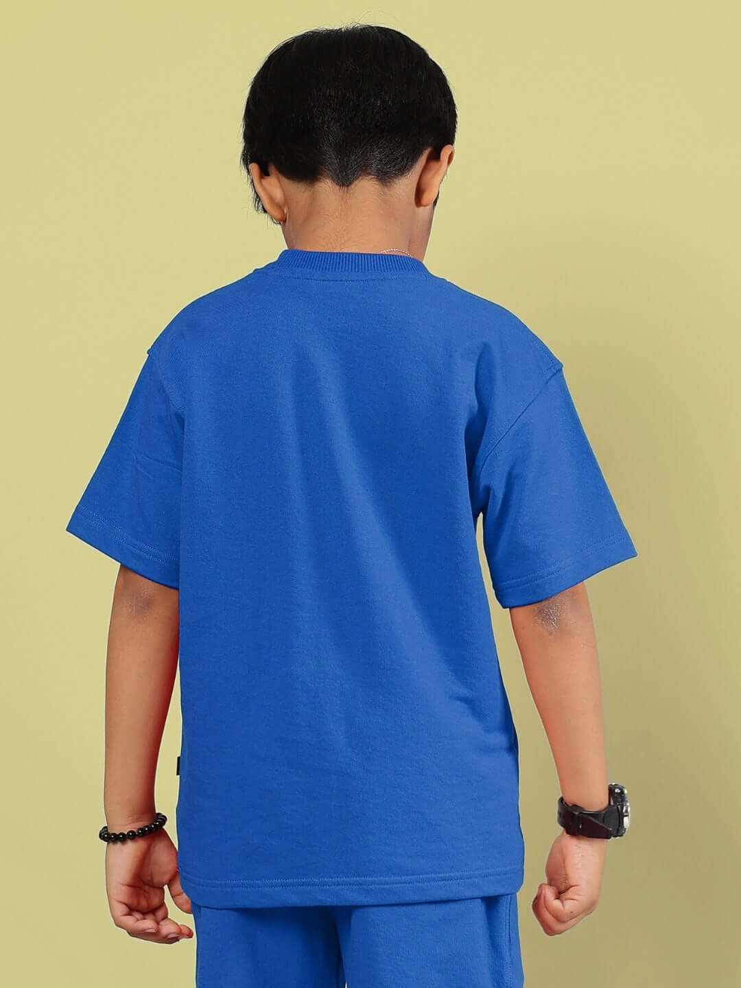 Child in blue Outlook T-shirt, back view, showcasing unisex design for boys and girls by DUDS, custom fit available.