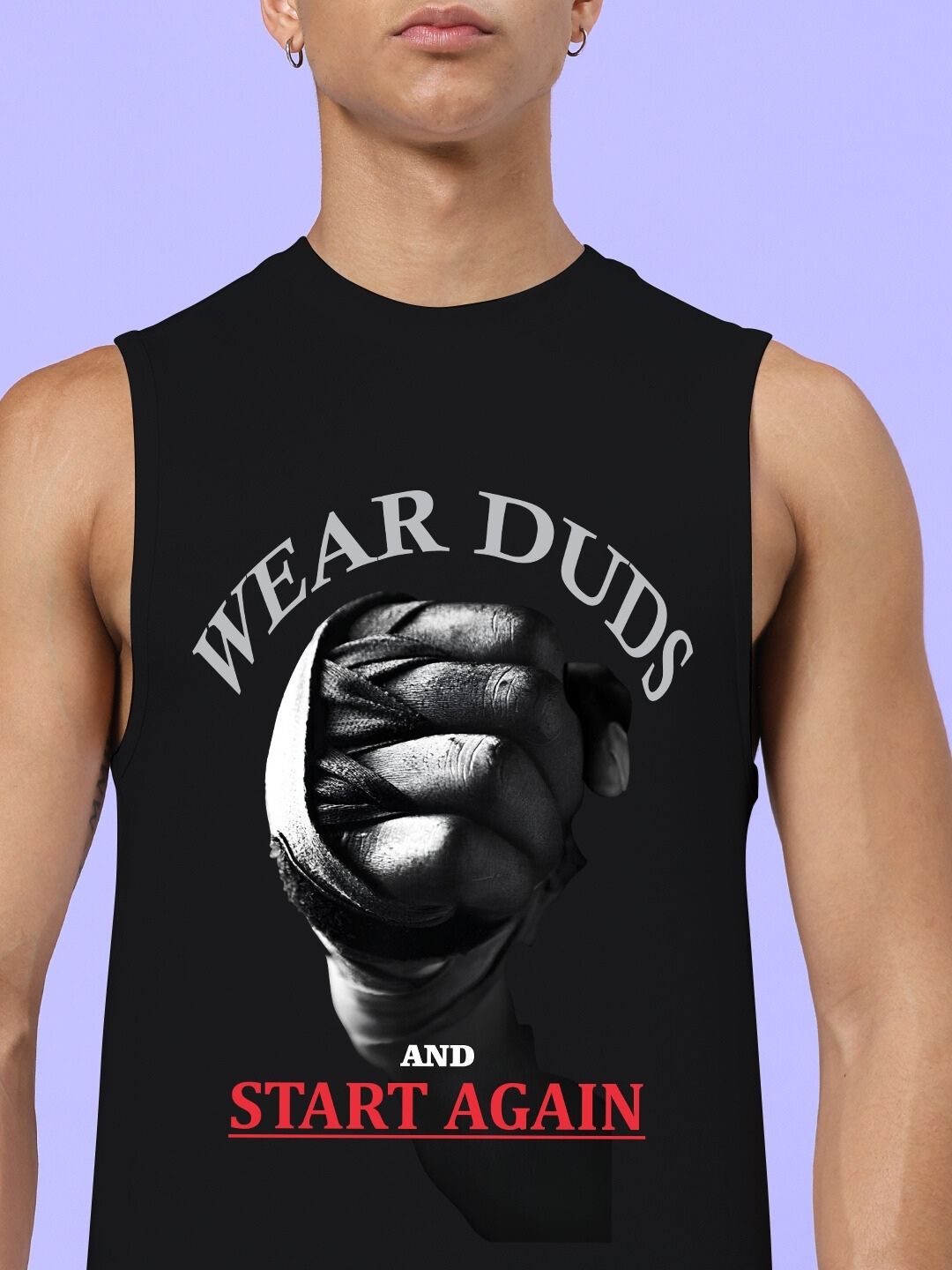 Man wearing gym shirt with motivational slogan "Wear Duds and Start Again" on a purple background.