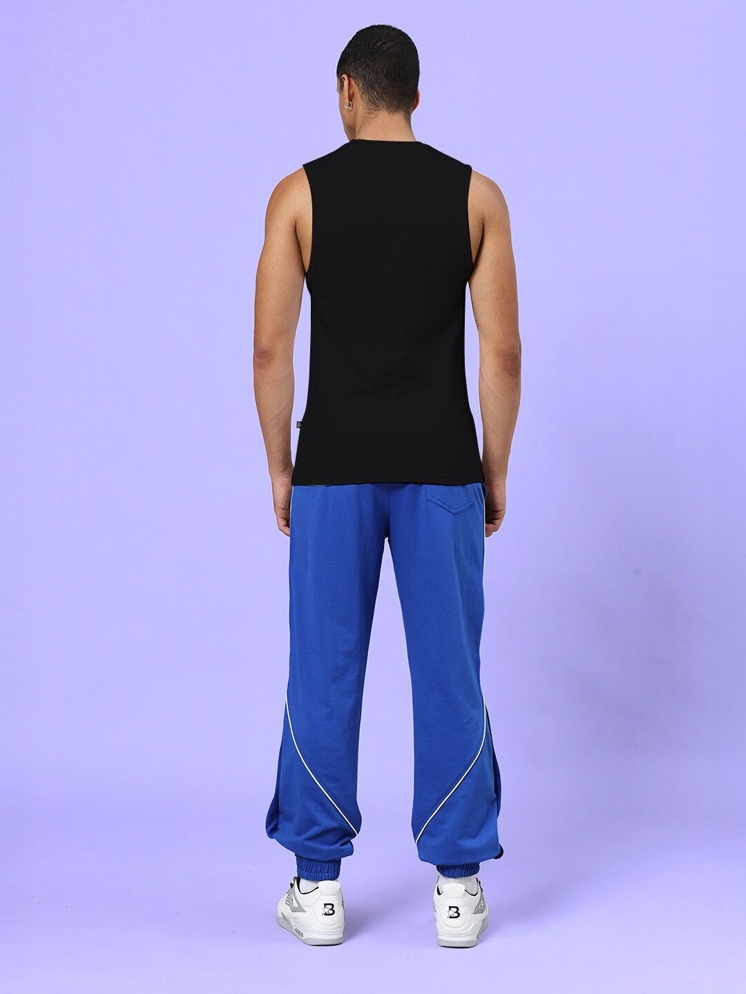 Back view of model wearing NEVER QUIT START AGAIN GYM CO-ORD SET BLACK ROYAL BLUE showcasing athletic design and bold colors.