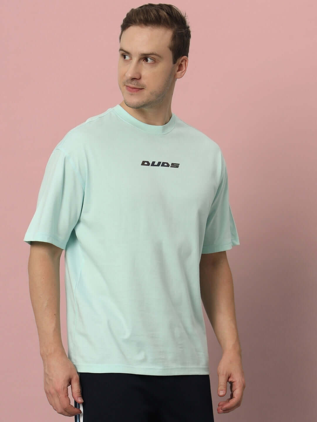 Man wearing LIVE GENTY UPON THIS EARTH OVER-SIZED T-SHIRT SKY BLUE with premium heavy gauge fabric, 100% cotton, 200 GSM bio-washed.