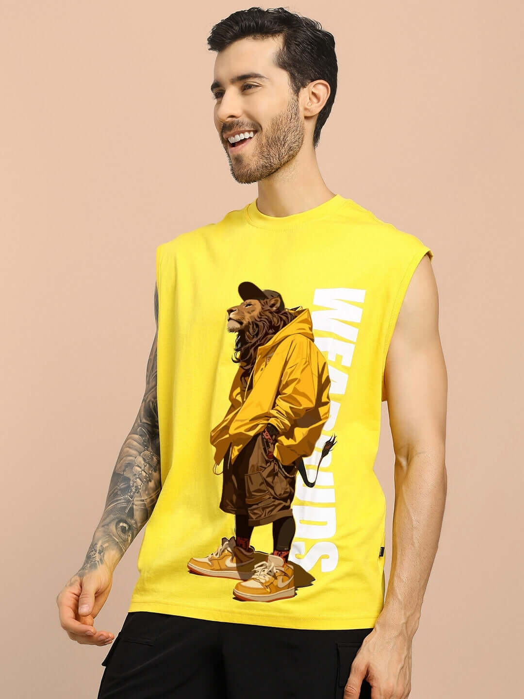 Man wearing yellow STREET LION GYM T-shirt with lion graphic, sleeveless design, and bold 'WEAR DUDS' text.