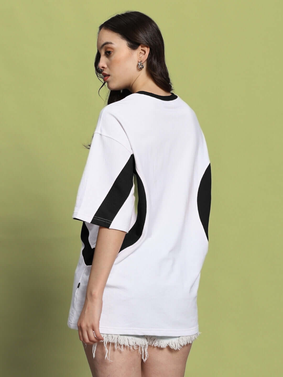 Model wearing Women's Ezel Oversized T-Shirt in White-Black, premium cotton blend, back view. Stylish casual wear, made in India.