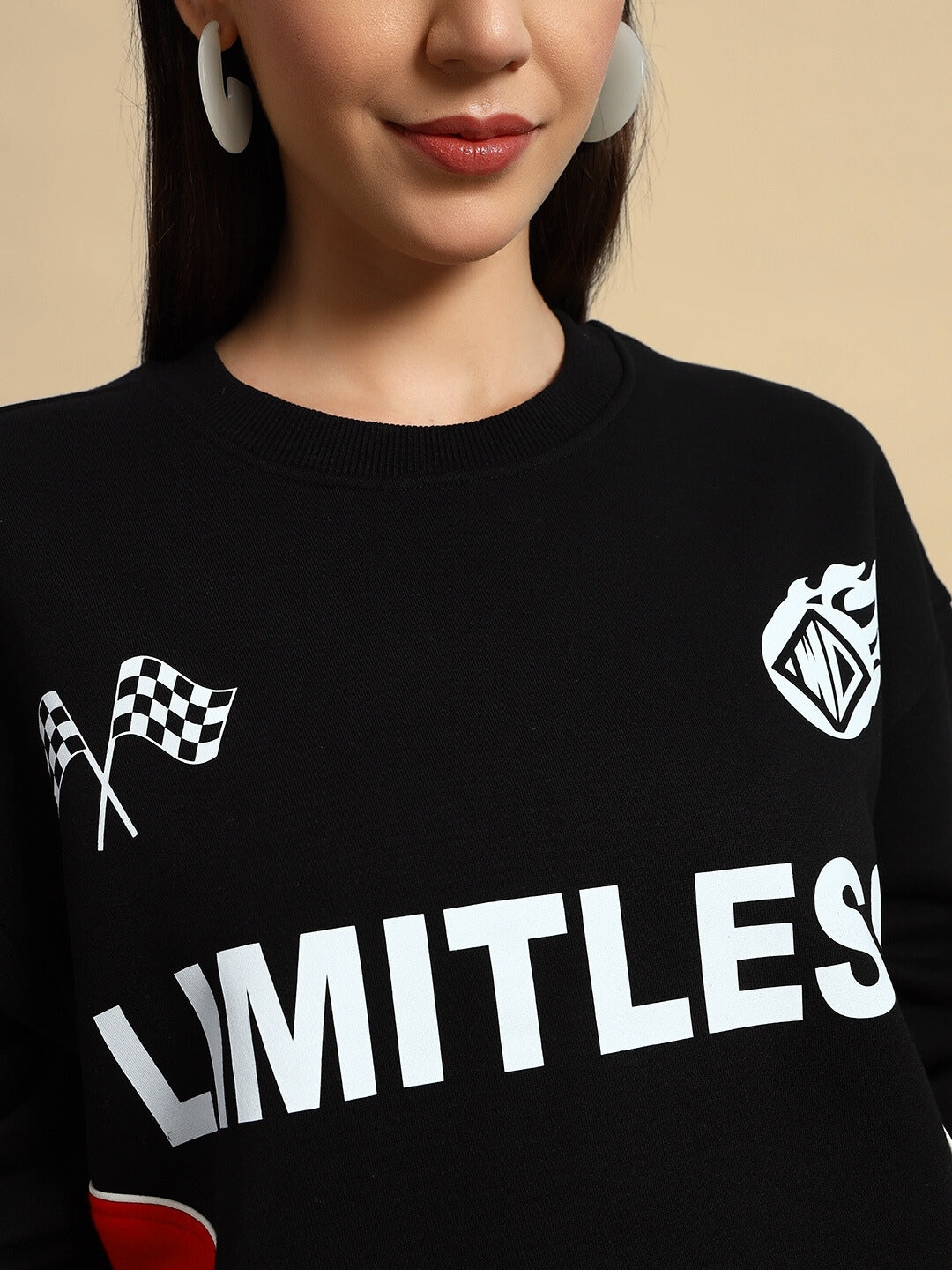 Close-up of WOMEN'S WD FIREBALL COLORBLOCK CO-ORD in black with 'LIMITLESS' text and racing graphics, showcasing bold streetwear design.