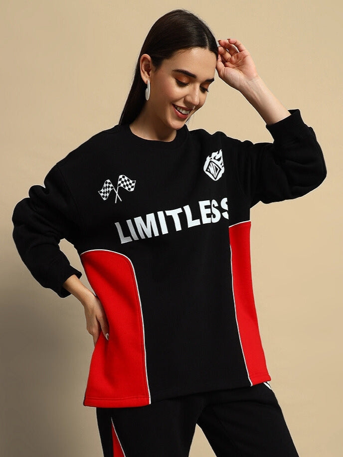 Woman in black and red colorblock co-ord with 'Limitless' print, emphasizing bold streetwear style and comfort.