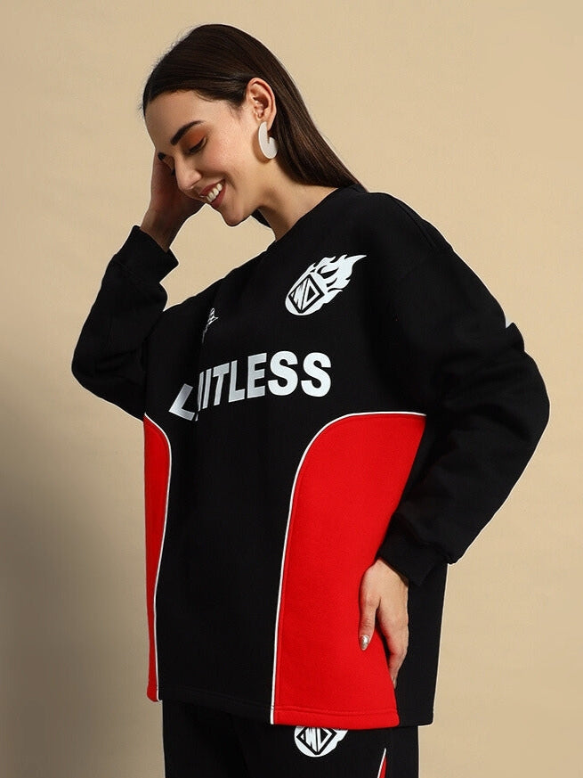 Woman wearing a black and red colorblock co-ord set with "Limitless" text, embodying bold streetwear style and comfort.