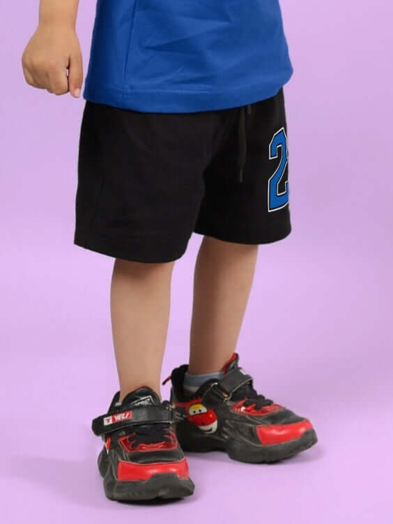 Child wearing AMIGA black blue shorts, part of made-to-order collection for boys & girls by DUDS, customizable fit available.