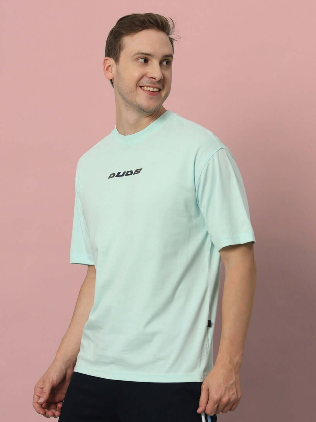 Model wearing LIVE GENTY UPON THIS EARTH OVER-SIZED T-SHIRT SKY BLUE, made from 100% cotton, bio-washed for softness and durability.