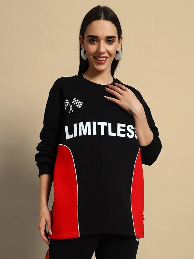 Woman wearing WOMEN'S WD FIREBALL COLORBLOCK CO-ORD in black-red with "LIMITLESS" text, showcasing streetwear style.