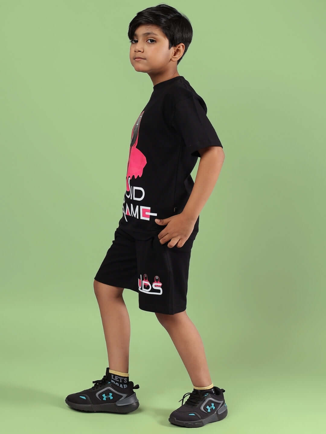 Child wearing black Squid Games co-ord set, side view, showcasing custom fit clothing option for boys and girls by DUDS.