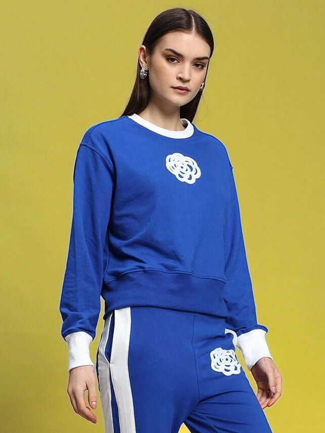 Woman wearing royal blue JessFlick sweatshirt with white accents, made from premium cotton French terry lycra blend.