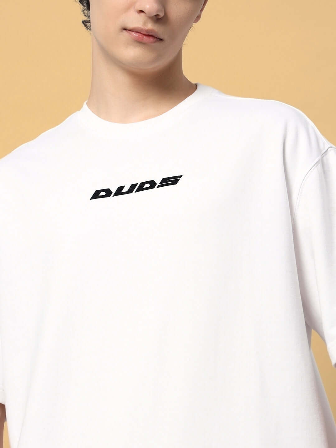 EIGHTFOLD PATH OVER-SIZED T-SHIRT WHITE on person with premium cotton fabric and 'DUDES' text, showcasing modern casual style.