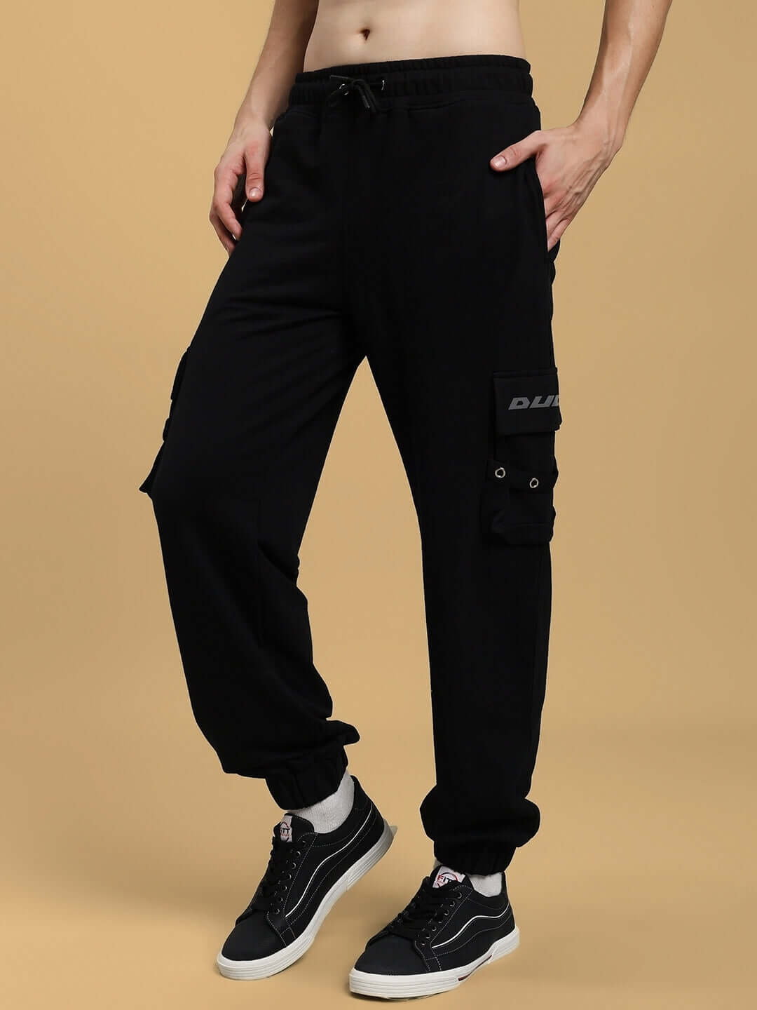 Man wearing DUDS Commando Joggers in black, showing style and comfort; customizable fit available for prepaid orders.