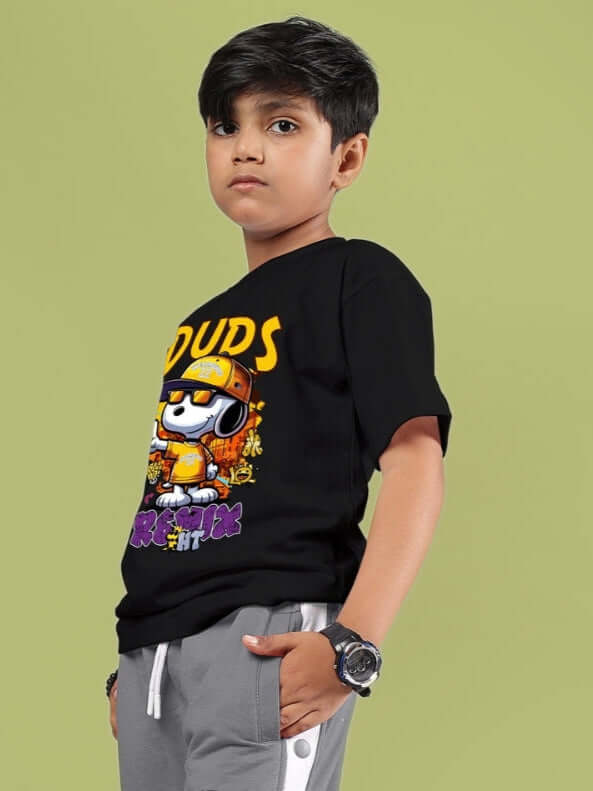 Boy wearing a black Snoopy Rimix T-shirt for boys & girls, showcasing vibrant design on a light green background.