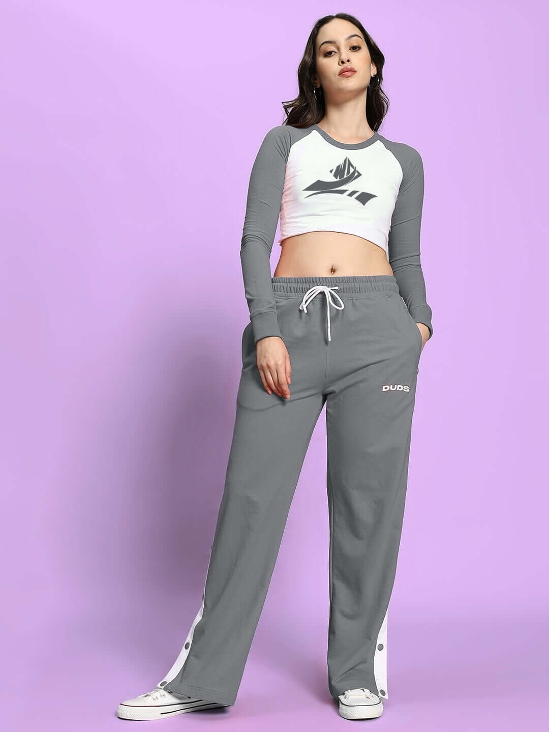 Woman wearing grey DUDS EZEL relaxed fit jogger with adjustable waist, showcasing comfortable, made-to-order style for custom fit.