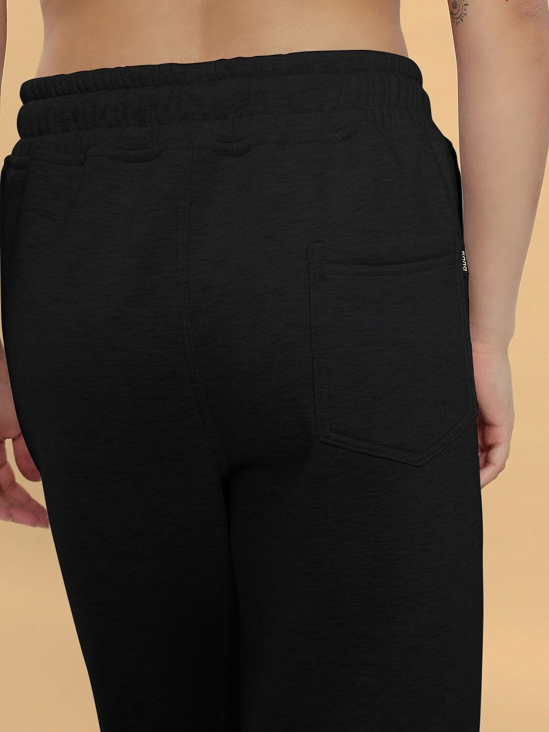 Back view of women's black Bona-Fide fleece pants featuring a single back pocket and elastic waistband.