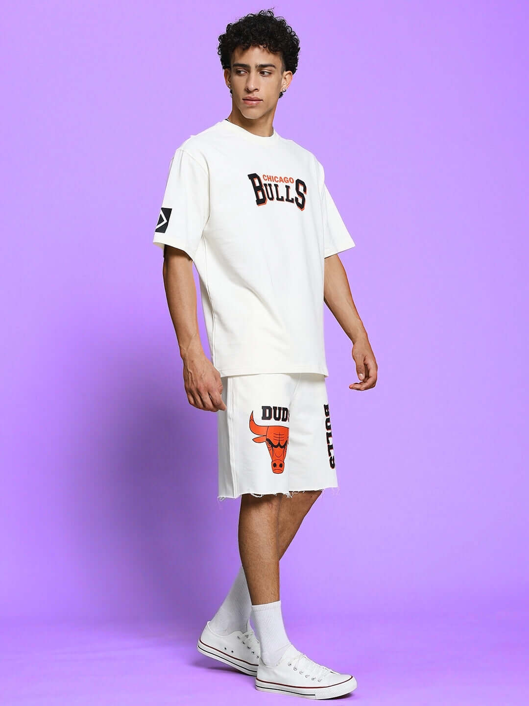Model wearing Blaze Bulls Print Co-ord Set in off white, featuring heavy gauge cotton fabric with Chicago Bulls design, against purple background.