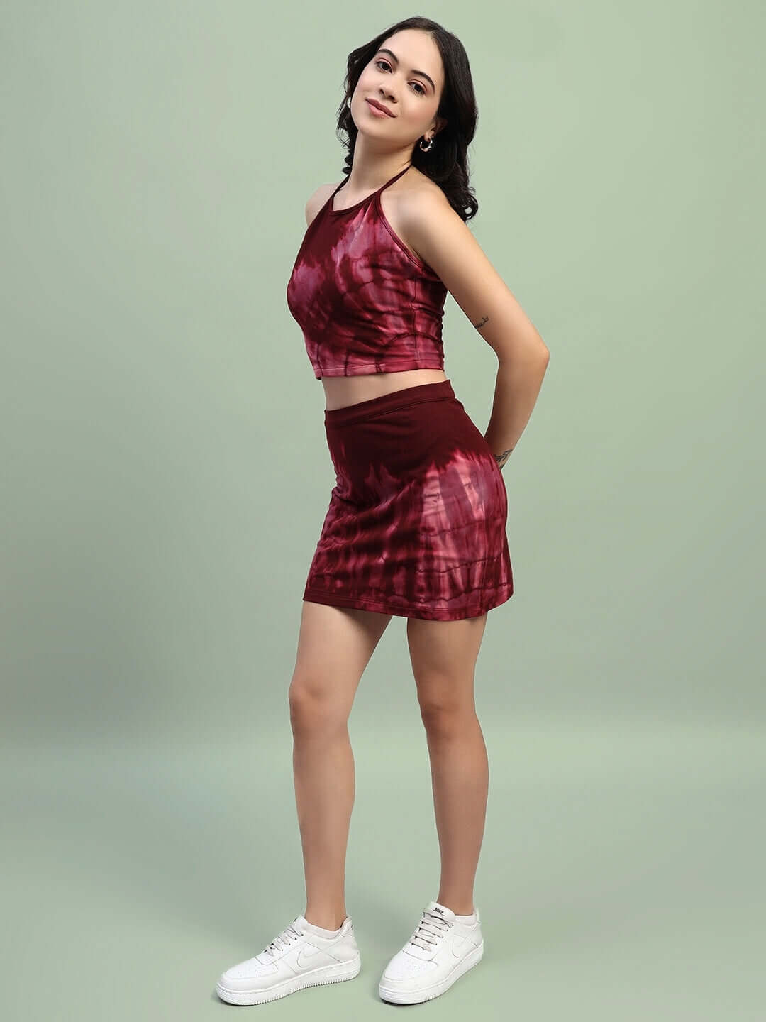 Model wearing maroon Layra tie-dye co-ord set, featuring a halter top and skirt, made from premium cotton and elastane blend.