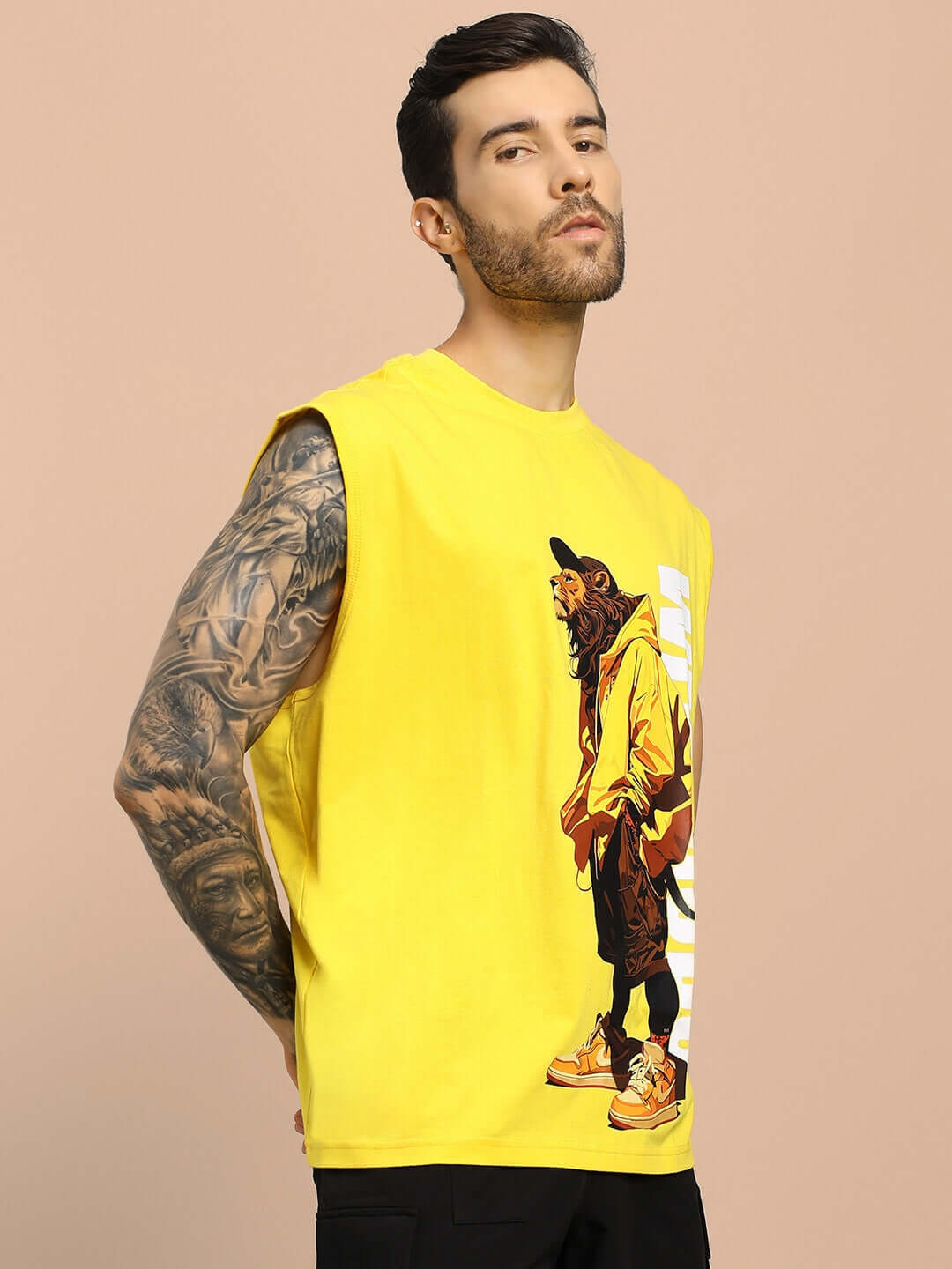 Man wearing STREET LION GYM T-SHIRT in yellow with a lion graphic, showcasing sleeveless design and custom fit option for perfect sizing.