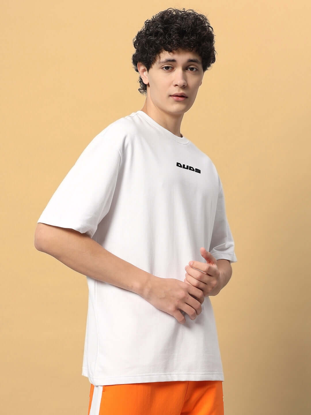 EIGHTFOLD PATH OVER-SIZED T-SHIRT WHITE made from premium cotton fabric, worn by a person against a neutral background.