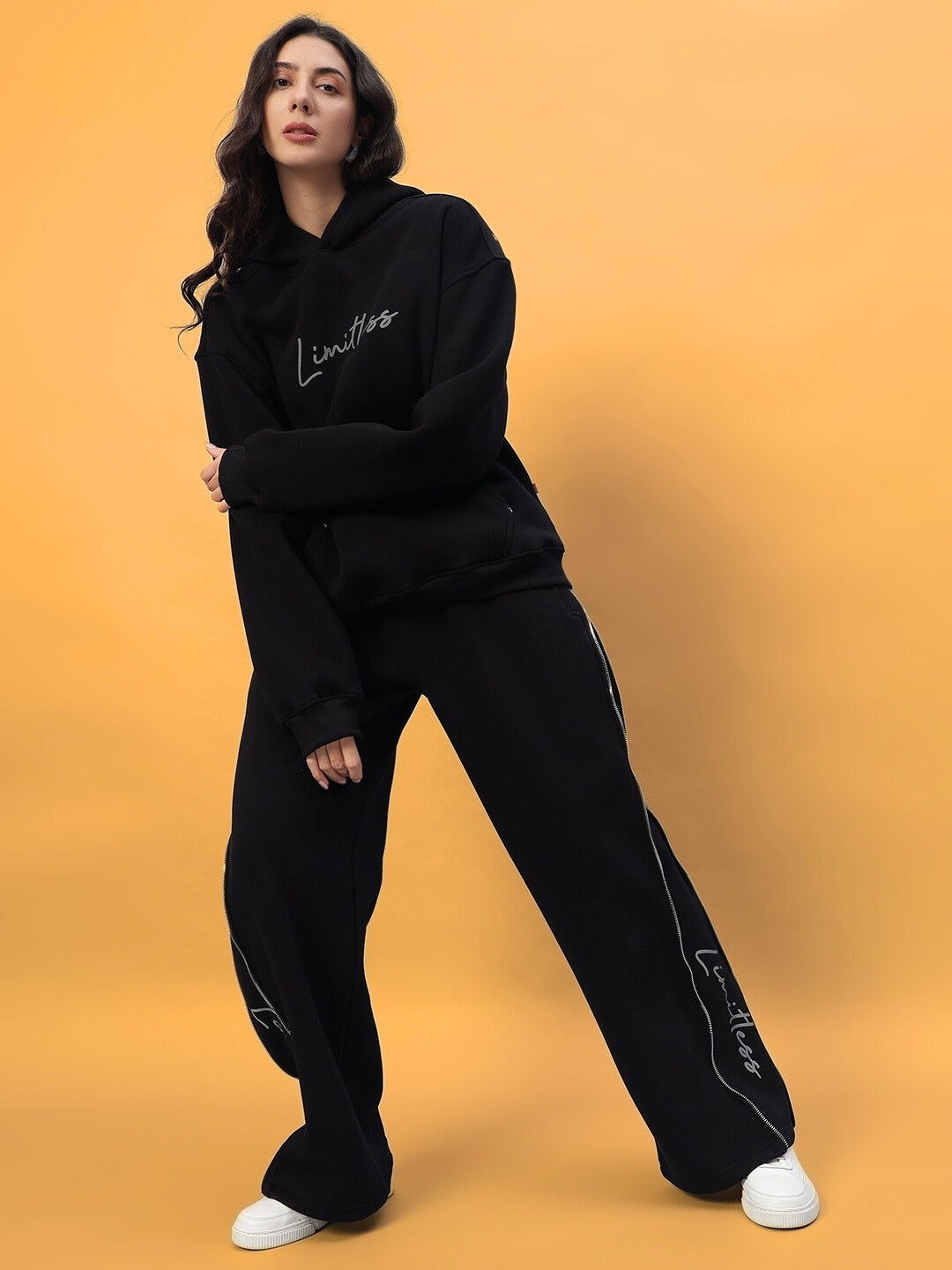 Woman wearing Women's Limitless Fleece Reflector Co-ord in black, featuring stylish design and comfortable fit, perfect for casual wear.