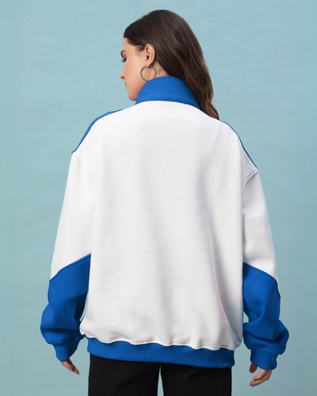Back view of a woman wearing a women's royal blue colorblock jacket, featuring a relaxed fit and crafted from premium fleece.