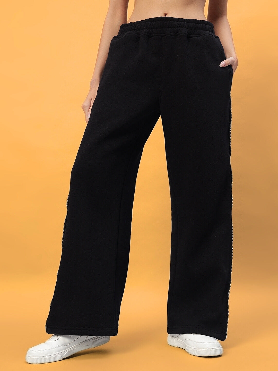 Women's black fleece jogger pants by DUDS, featuring a relaxed fit and reflector details, ideal for casual and comfortable wear.