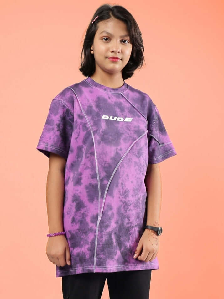 Alt Tag: Purple Ghost Rider tie-dye t-shirt for boys and girls, made to order by DUDS, worn by a girl against an orange background.