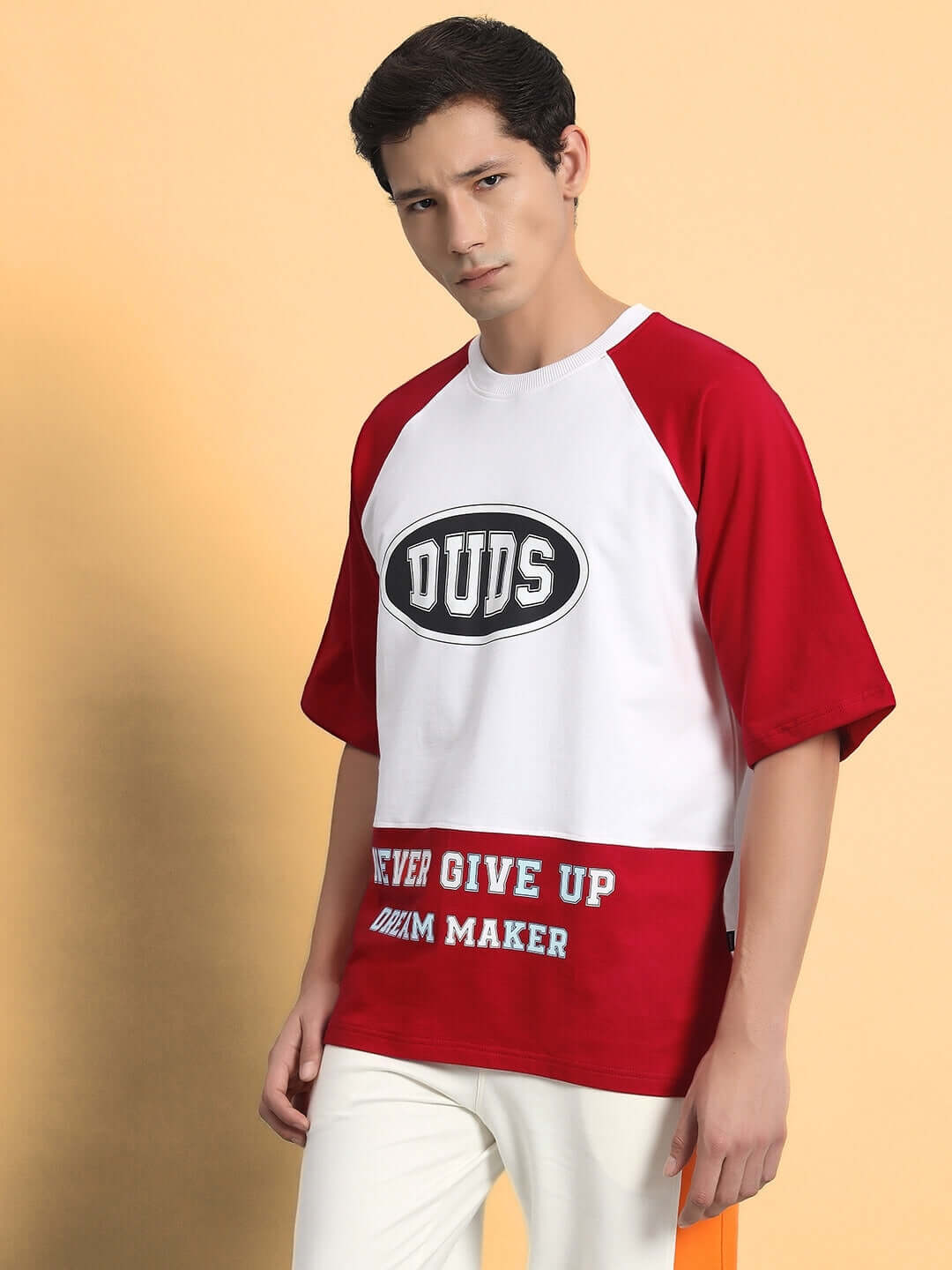 Man wearing NEVER GIVE UP OVERSIZED T-SHIRT RED with bold text design, facing forward on a plain background.