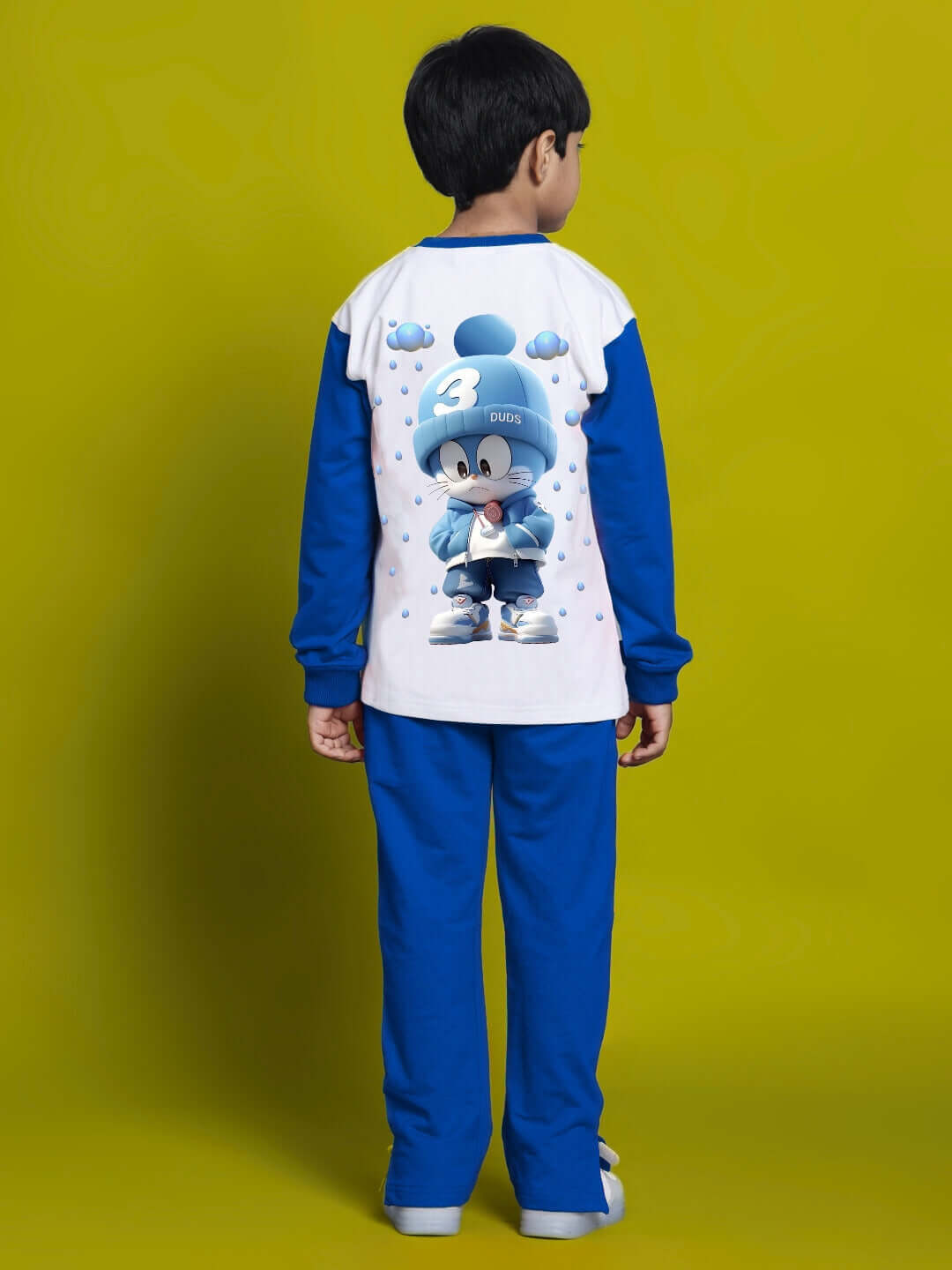 Child wearing a white and blue Doraemon sweatshirt with premium cotton fabric, designed for boys and girls, against a yellow background.