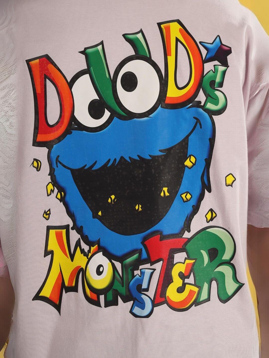 Graphic on the back of DUDS MONSTER OVER-SIZED T-SHIRT PALE PINK with colorful monster design.