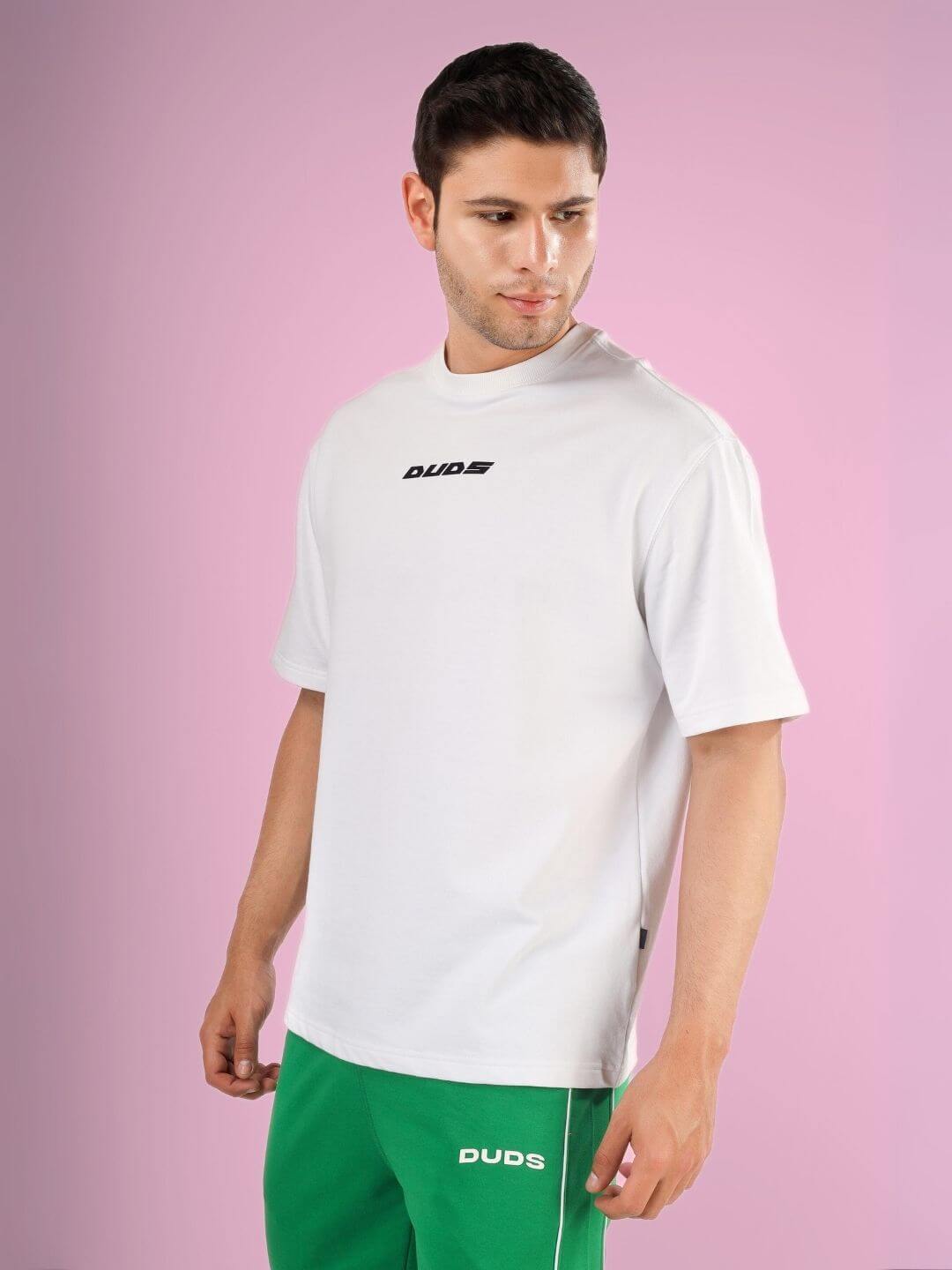 Man wearing DONT STOP OVER-SIZED T-SHIRT WHITE made of premium heavy gauge fabric with 97% cotton and 3% elastane.