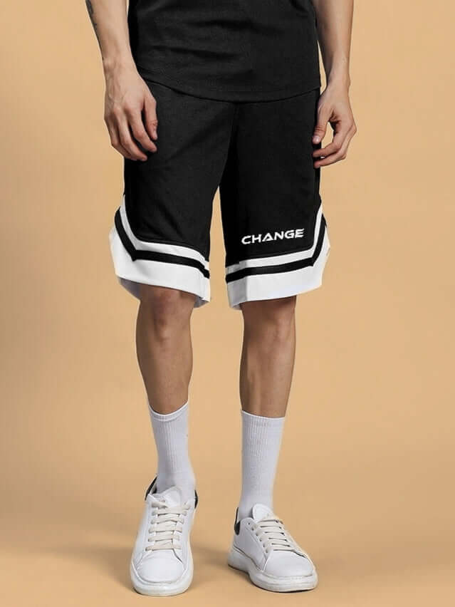Man wearing black regular fit shorts with white trim, labeled 'CHANGE'. Perfect for casual wear, customizable options available.