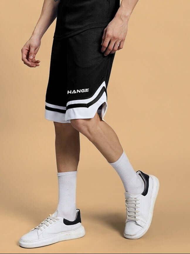 Model wearing black CHANGE YOUR LOOKS regular fit shorts with white stripes, showcasing sporty style. Available in custom fit option.