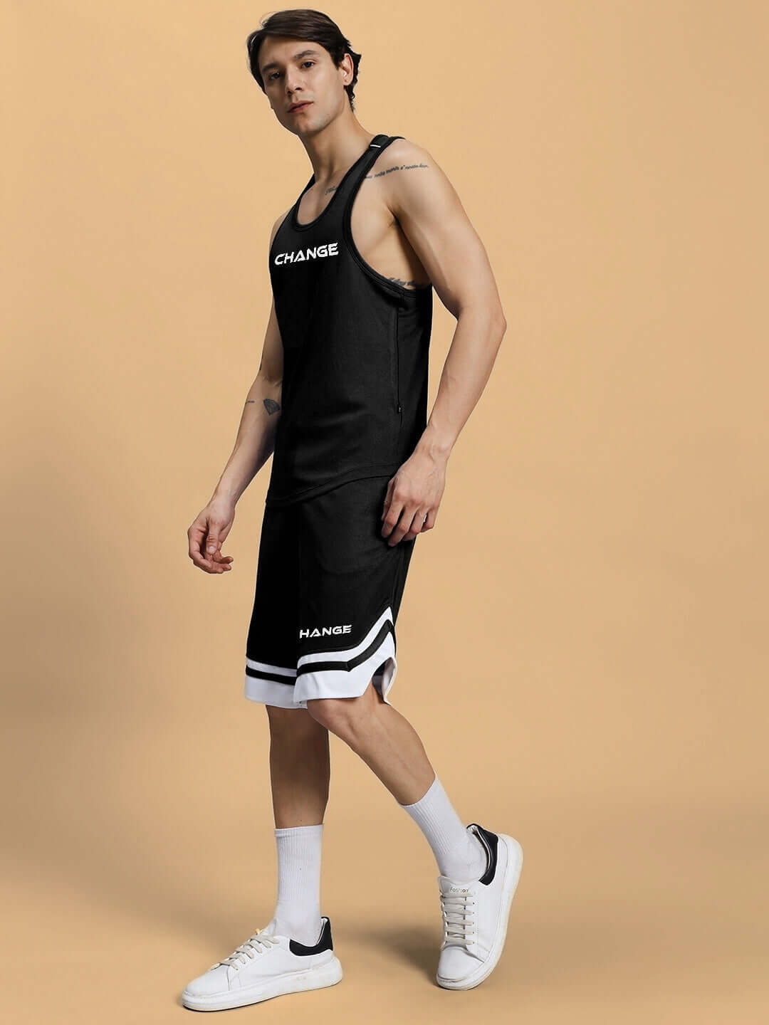 Model wearing the black Change Your Looks Gym Co-Ord Set, featuring a sleeveless top and shorts, made from sports polyester fabric.