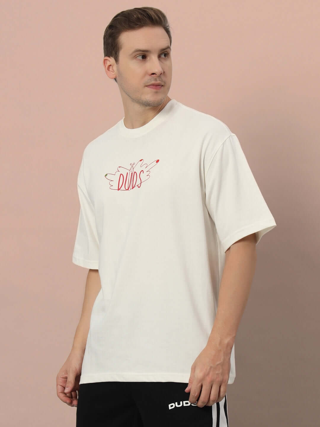 Man wearing ONE STEP AT A TIME OVER-SIZED T-SHIRT OFF WHITE made from premium heavy gauge cotton fabric with graphic design.
